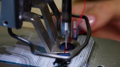 Close Up of Sewing Machine Stitching Blue Fabric