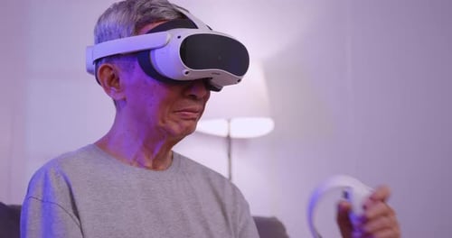 Senior Man Enjoys Virtual Reality Experience at Home