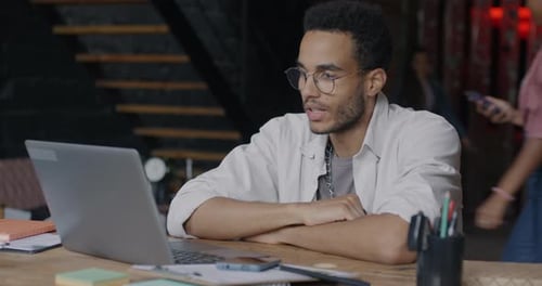 African American Entrepreneur Talking During Online Video Call Concentrated on Virtual Meeting in