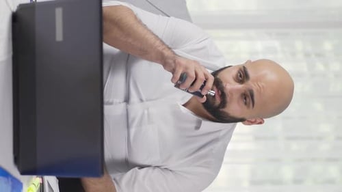 Vertical video of Home office worker sprays perfume on man.