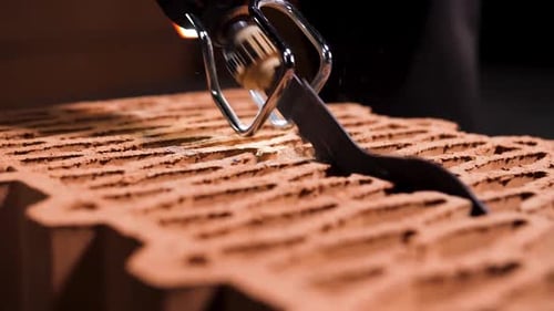 Electric Saw Cutting a Brick on Black Background