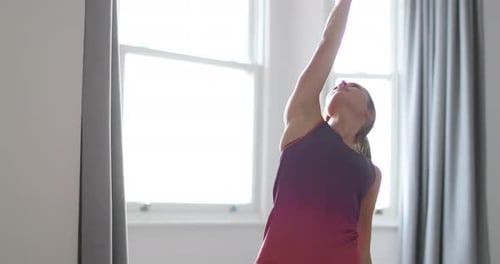 Woman Stretching and Doing Yoga in Bright Room