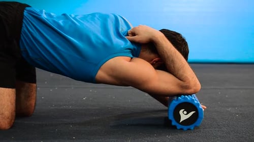 Man Using Foam Roller for Arm and Shoulder