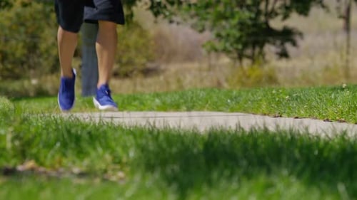 Man Running on Trail at Park Closeup of Feet Active