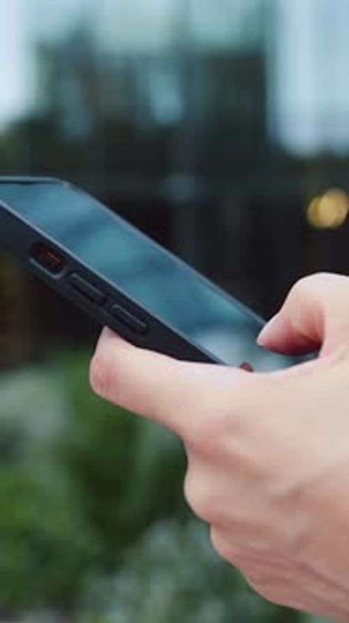 Close Up of Woman Hand Use Phone Hand of Woman Using Texting Mobile Phone or Chat Outdoors Slow