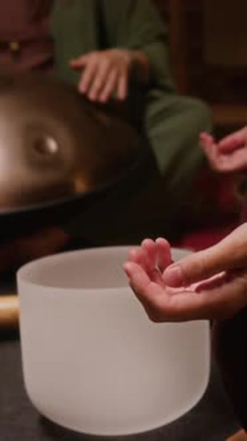Vertical of Female Guest Meditating during Hang Drum Sound Healing Session