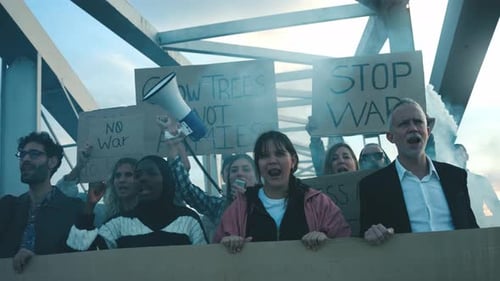 Diverse Group of Protesters Holding Signs and Shouting