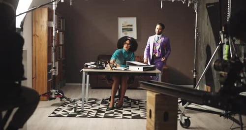 Woman Reviews Documents with Man in Purple Suit