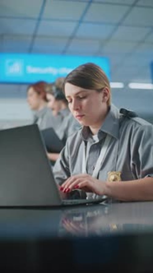 Airport Security Female TSA Officer Using Laptop Smiling and Looking at Camera