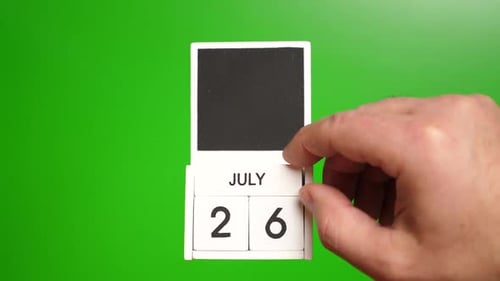 Hand Changing Date on Calendar to July 26