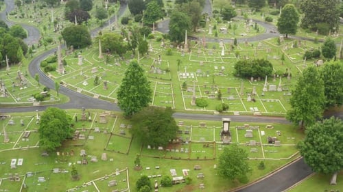 Rising aerial of Hollywood Cemetery in Richmond Virginia, USA. Drone into clouds. Green summer view