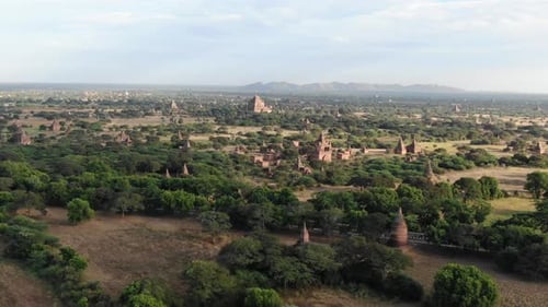 Ancient Buddhist temple in Bagan, Myanmar with more in background. Aerial shot.