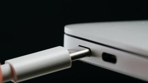 Charging Connection to Laptop on Black Background Closeup Phone Charging Port USB Wire for Devices