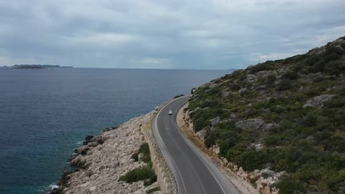 Aerial View of Car Driving Beautiful Road Along the Aegean Sea