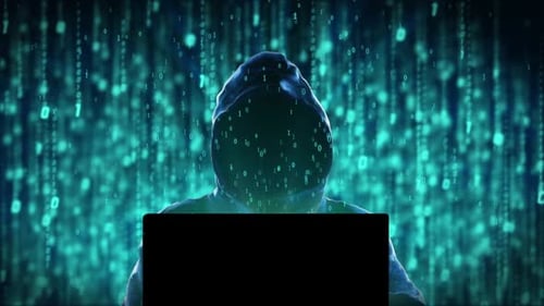 Anonymous Hacker Silhouette Typing on Laptop with Digital Matrix Rain