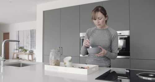 Woman Eating Healthy Breakfast in Modern Kitchen