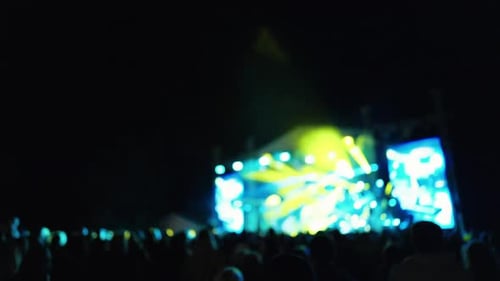 Crowd at Night Concert with Bright Stage Lighting