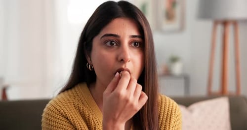 Shocked, woman eating and watching tv in home with popcorn for horror movie