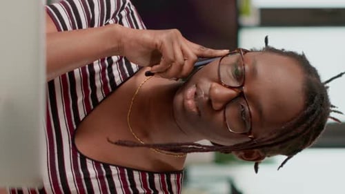 Woman Talks on Smartphone Indoors in Vertical Video