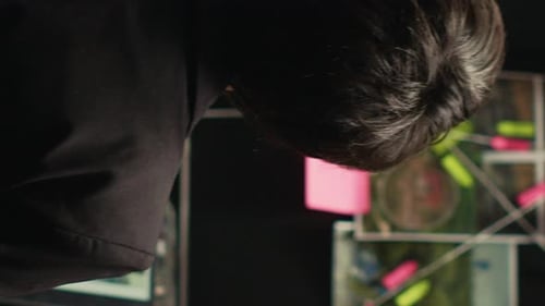 Looking at Paperwork Next to Police Wall