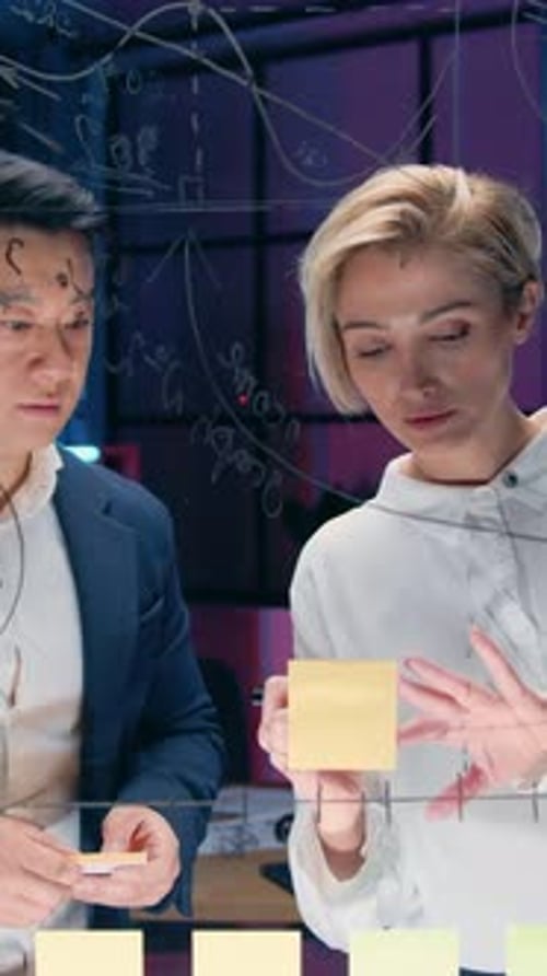 Professionals Work Together on Sticky Note Problem Solving