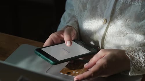 Woman Paying Online Using Bank Card and Smartphone