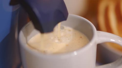 Close-Up Of A Cup Of White Coffee Dripping From A Coffee Maker.