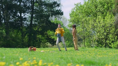 Dad Throws Child in Air at Park Picnic