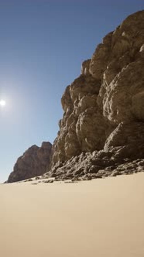 Sunlit Desert Cliff Against Clear Sky