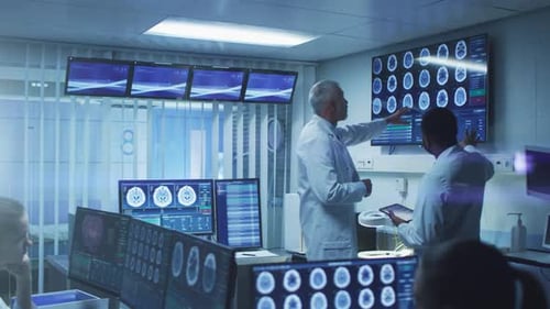 Medical Professionals Analyzing Brain Scans in Hospital Room