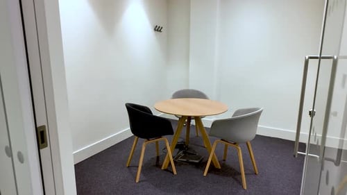 Empty Meeting Room with Round Table and Chairs