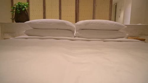 white pillows decoration on bed in luxury hotel resort bedroom
