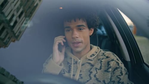 Young Adult Talking on Phone in Car