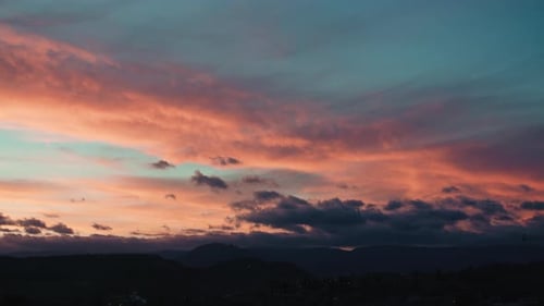 Beautiful Clouds over Dark Mountain Landscape at Sunset