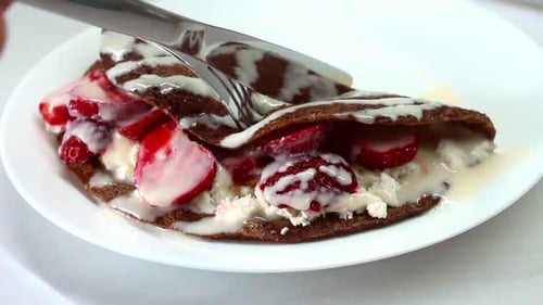 Close Up of Dessert Crepe Being Cut