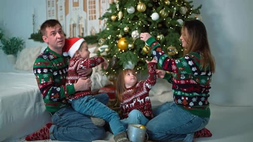 Festive Family Decorating Christmas Tree in Home