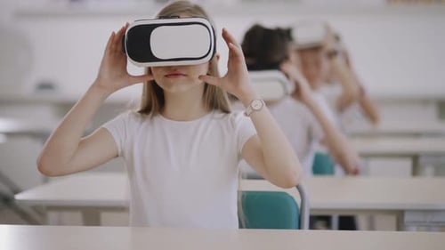 Girl Taking off VR Headset in Classroom