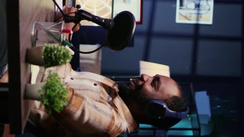 Man with Beard and Headphones Recording Podcast