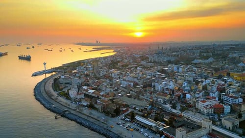 Aerial drone view of Istanbul at sunset, Turkey. Multiple buildings and The Blue Mosque on the coast