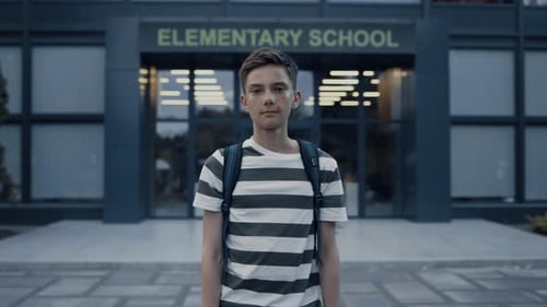 Close Up of Serious Teen Boy Standing at Empty Schoolyard. Tensed Schoolboy