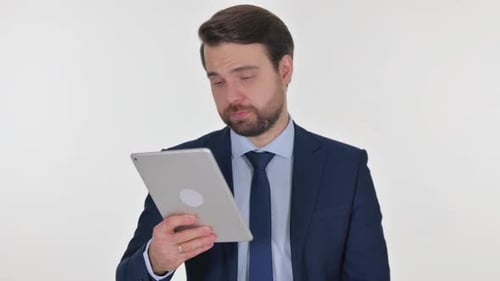 Man Cheers While Using Digital Tablet Device