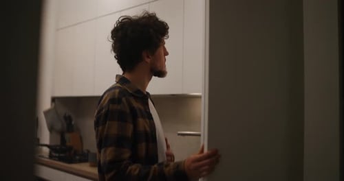 Man Taking Dish from Refrigerator in Modern Kitchen