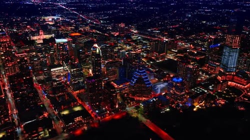 Austin Texas city skyline at night with illuminated skyscrapers.