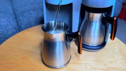 Filling Stainless Coffee Pot with Water – 4K Close-Up of Kitchen Prep Moment.