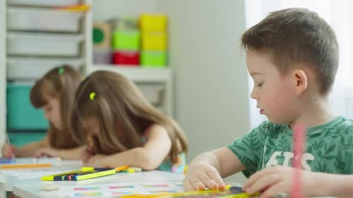 Schoolchildren Perform the Tasks of a Teacher at Desks in an Elementary School