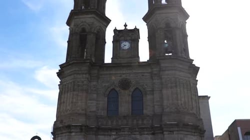 Church in little town. Camera tilt from bottom to top.
The sky is blue with some clouds.