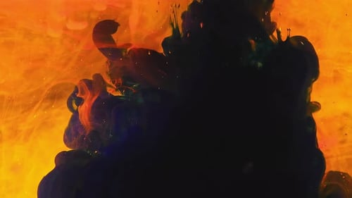Abstract Ink Flowing in Golden Yellow Liquid