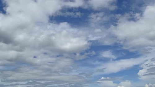 Clouds Moving Across a Bright Blue Sky