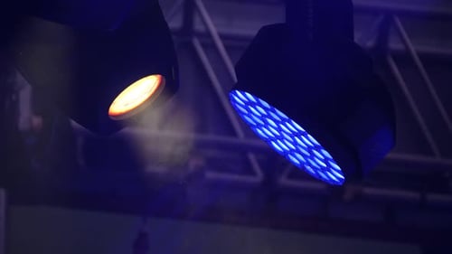 Stage Lights Turning on Creating Beams in a Smoky Atmosphere