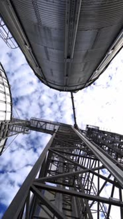 Large industrial plant with storage tanks. Silver grain elevators for agribusiness